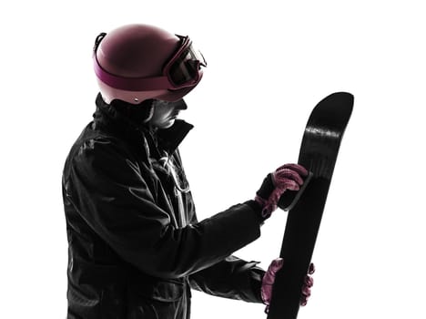 one caucasian woman skier skiing polishing ski in silhouette on white background