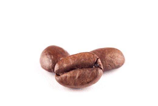 Three Coffee beans on wihte background, macro