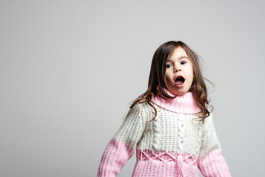 Adorable little girl with long hair moving left