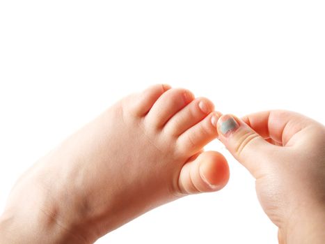 Girl grabbing toe on left foot with right fingers from right hand, isolated towards white background