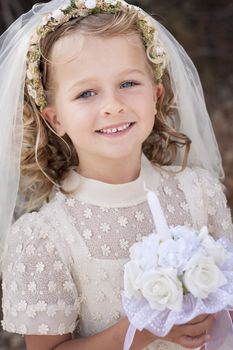 A young child doing her first holy communion