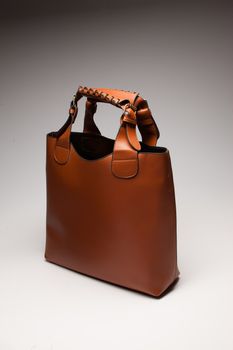 brown leather womans bag over white