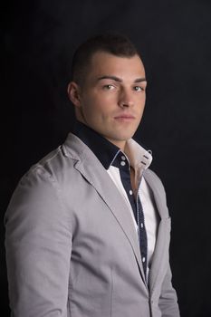 Portrait of handsome young man with shirt and jacket, looking at camera