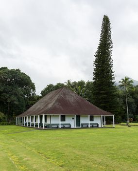 The old Waioli Huiia Mission building and hall in Hanalei Kauai with the Na Pali Mountains shrouded in mist in the background