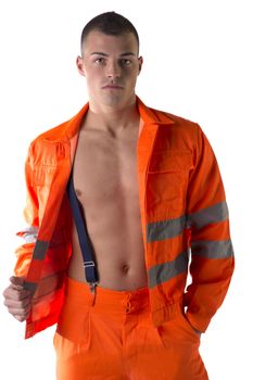 Handsome young construction worker with orange suit open on naked torso