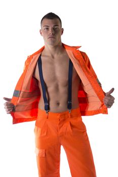 Handsome young construction worker with orange suit open on naked torso