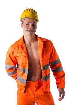 Handsome young construction worker with orange suit open on naked torso, smiling