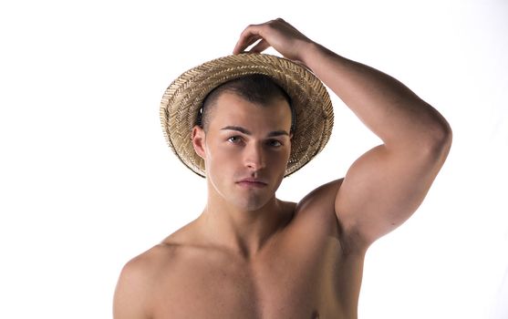 Shirtless attractive young man with straw hat, isolated on white background