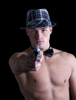 Attractive shirtless young man with black bow-tie and grey fedora hat pointing gut at camera
