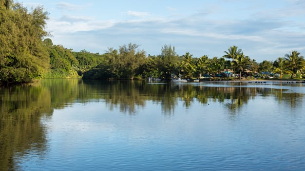 Wide mouth of Hanalei river as it flows into the ocean on beautiful island of Kauai in Hawaii