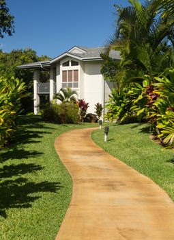 Pathway leads through tropical plants at hotel or timeshare holiday vacation resort