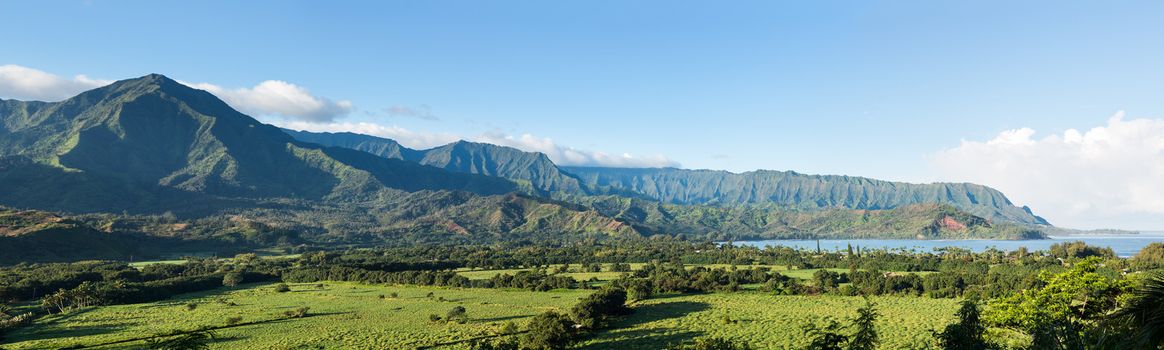 High resolution stitched panorama of the bay at Hanalei in Kauai with the Na Pali mountain range in the background. Taken just after dawn with lighting highlighting the valleys in the mountains