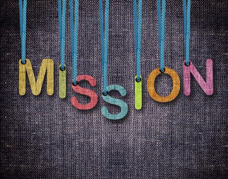 mission Letters hanging strings with blue sackcloth background.