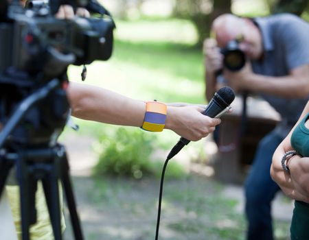 A journalist is making a interview with a microphone