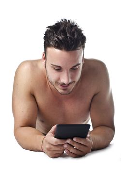 Attractive, fit young man holding ebook reader or tablet, smiling, isolated on white