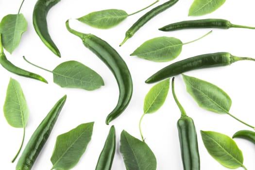 green hot chili pepper with leaves on a white background