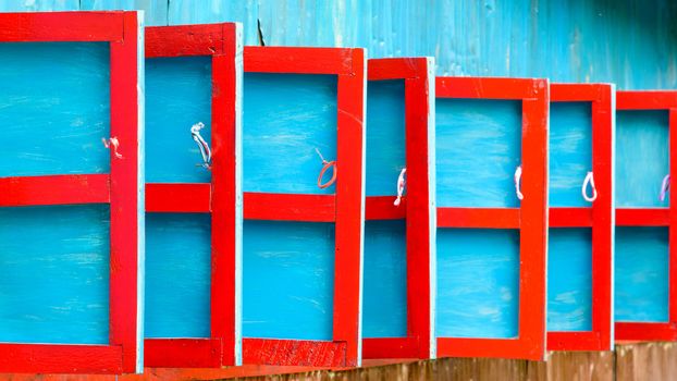 Red and blue wooden shutters detail