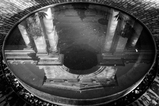 Ancient building reflection in water in black and white