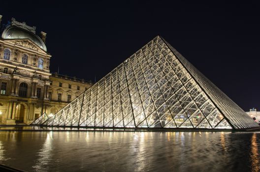 PARIS-DEC 27: Louvre museum is a triangular pyramid for an art exhibit December 27, 2013 in Paris.