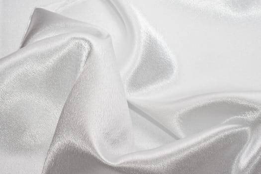 Abstract background white silk fabric with beautiful waves