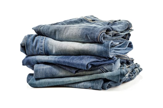 Folded Old Blue Jeans Isolated on a white. Clipping path included.