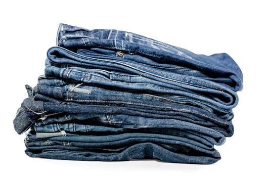 Folded Old Blue Jeans Isolated on a white. Clipping path included.