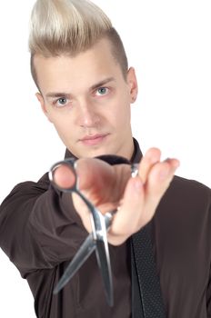 Portrait of stylish man with pair of scissors in studio isolated on white