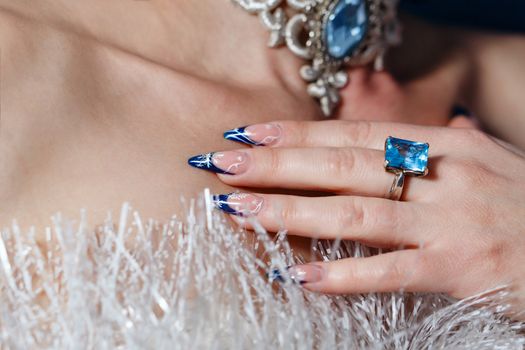 Crack nail polish on female fingers and beautiful jewels shot closeup