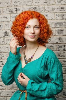 Attractive young girl with red hair in a studio portrait