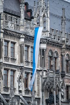 Town Hall architecture detail in Munich with bavarian Flag