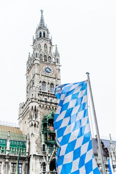 Munich Town Hall with bavarian flag in the foreground