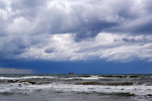 Waves of the Black Sea, Anapa, Krasnodar Krai. The ship in the sea on the horizon.