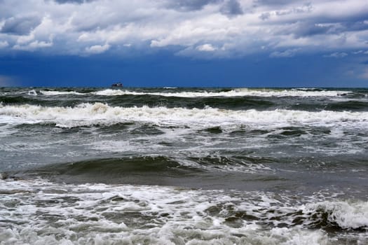 Waves of the Black Sea, Anapa, Krasnodar Krai. The ship in the sea on the horizon.