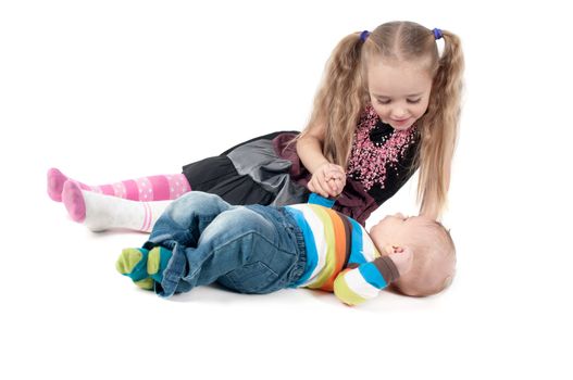 Shot of newborn baby boy with sister lying on white background