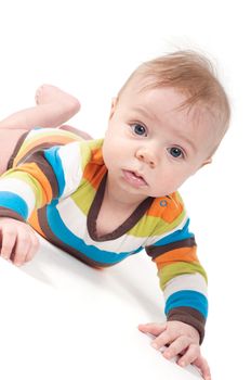 Tiny baby in striped clothes lying on white background