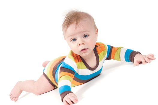 Small baby in striped clothes lying on white background