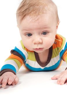 Little baby in striped clothes lying on white background