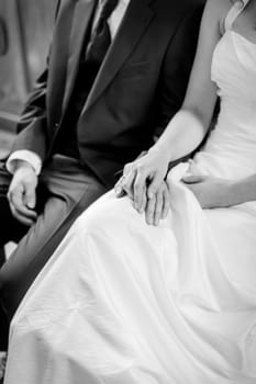 bride and groom sitting on a bench on their wedding day