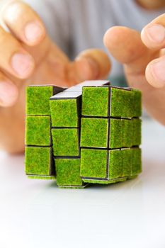 hand holding green rubik's cube concept