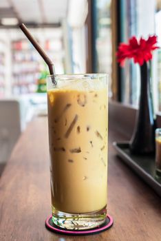 Iced coffee on the wooden table in coffee cafe.