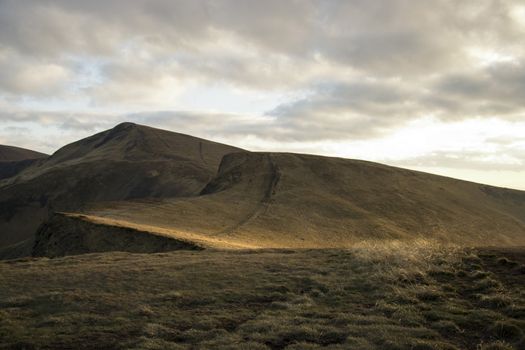 Mountain peaks in the autumn evening sky with clouds