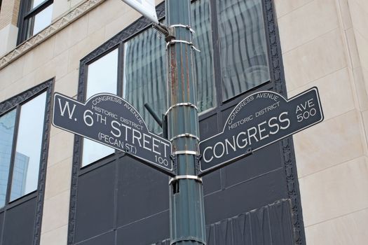 Sign at the intersection of West 6th Street (Pecan Street) and Congress Avenue in the Congress Avenue historic district at the bustling center of Austin, Texas