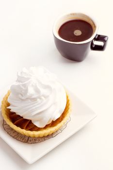 Cake with whipped cream and black coffee