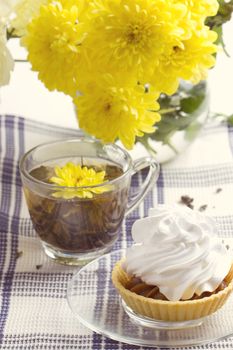 Romantic breakfast. Tea, cake, yellow chrysanthemum