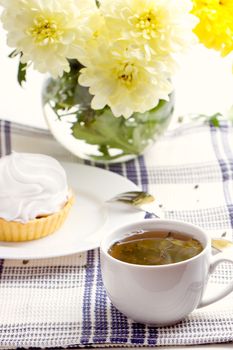Romantic breakfast. Tea, cake, yellow chrysanthemum