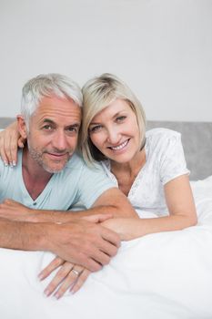 Closeup portrait of a mature couple lying in bed at home