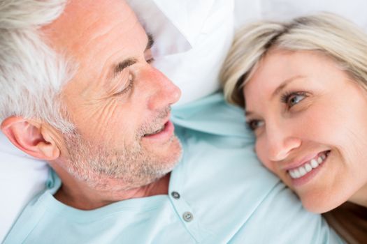 Closeup portrait of a mature couple lying in bed at home