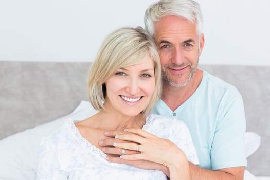 Closeup portrait of a loving mature couple in bed at home