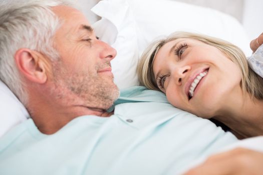Closeup portrait of a mature couple lying in bed at home