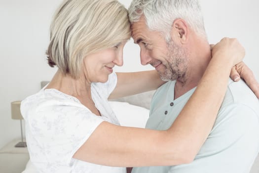 Closeup side view of a loving mature couple at home